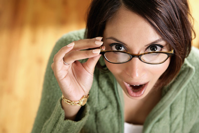 Close-up of a young woman holding her eyeglasses